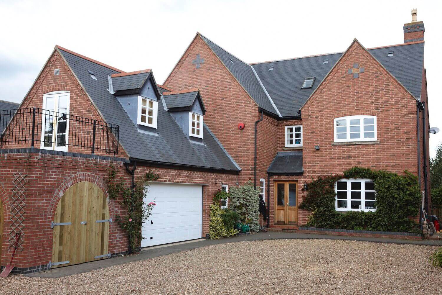 Red brick house with white windows and a white garage